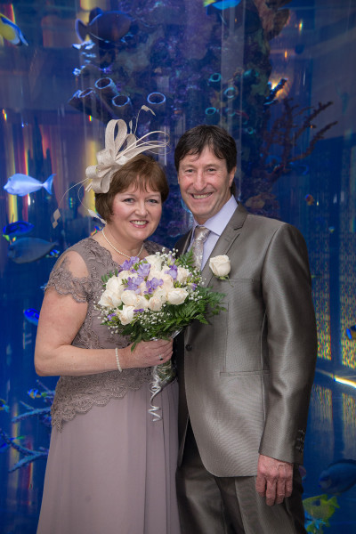 Ben Asen Celebration Photo: Bride and groom in front of a large fish tank in New York City