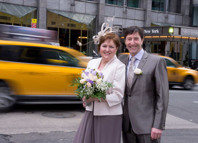 Ben Asen Celebration Photo: Bride and groom in New York City with taxis and New York sign in the background