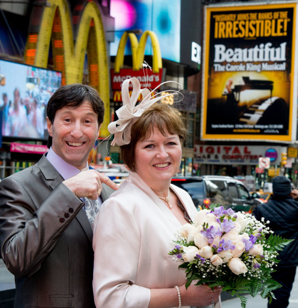 Ben Asen Celebration Photo: Bride and groom in Times Square New York with sign saying irresistible and beautiful