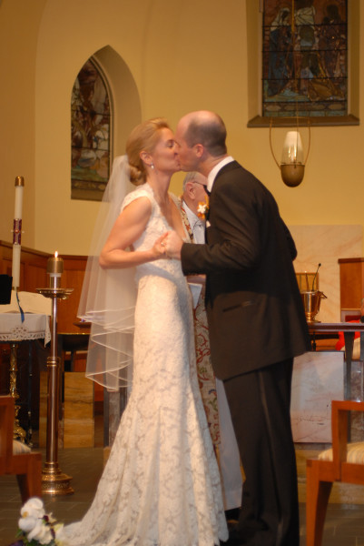 Ben Asen Celebration Photo: Bride and groom kissing at their church wedding