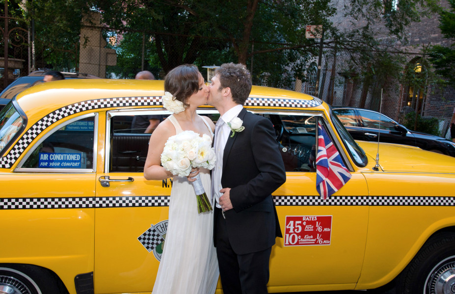 Ben Asen Celebration Photo: Color photo of bride and groom kissing in front of New York City Checker cab with a British fag