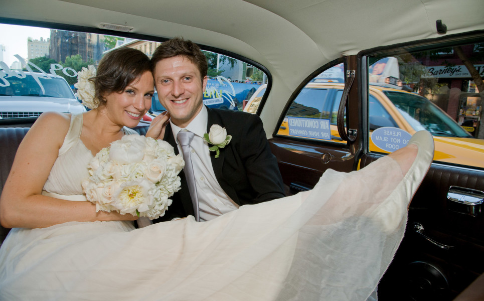 Ben Asen Celebrations Photo: Color photo of bride and groom sitting in a New York City taxi