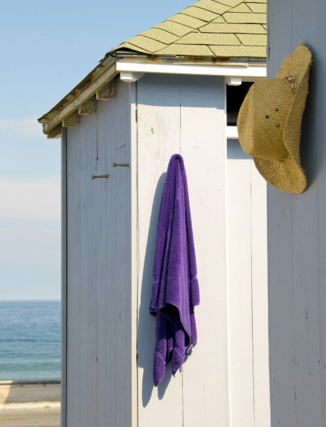 Ben Asen Personal Work Photo: Color photo of beach cabana with hanging purple towel and straw mens style cowboy hat with ocean in the background.