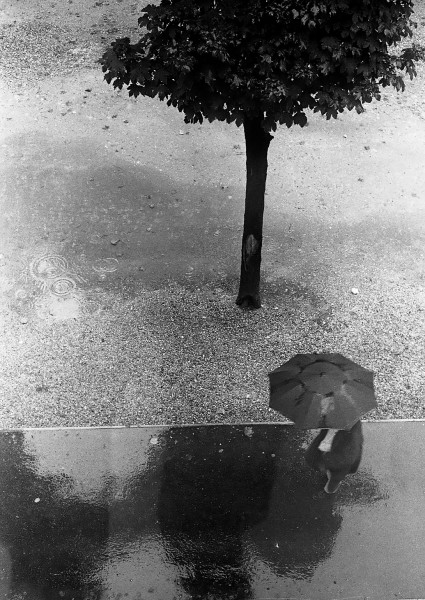 Ben Asen Personal Work Photo: Black and white photo of man walking with umbrella in the rain in Paris, France.