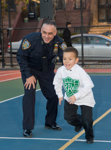 Ben Asen Editorial Photo: Police Athletic League (PAL) of NYC, with a PAL Police Officer with a Young Boy