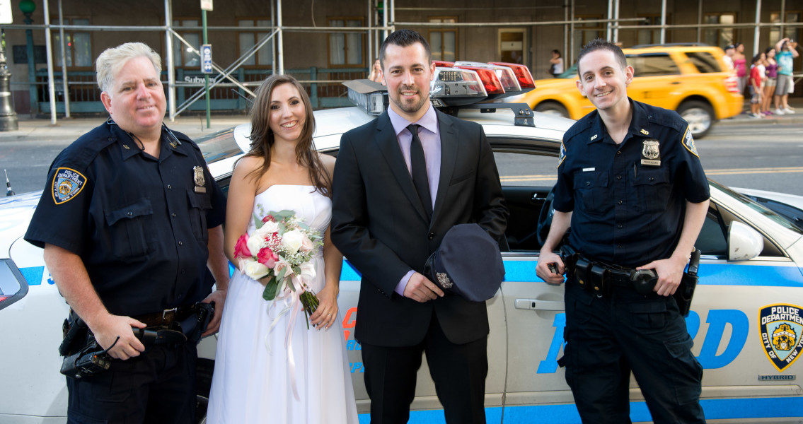 Ben Asen Celebrations Photo: Bride and groom posing with New York City Police in front of patrol car
