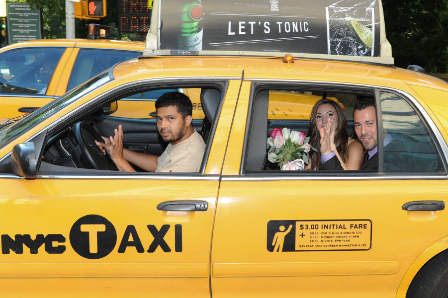 Ben Asen Celebrations Photo: Bride and groom looking out the window of New Yotk City taxi