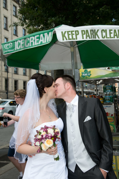 Ben Asen Celebrations Photo: Bride and groom kissing in front of a hot dog stand in New York City for a wedding