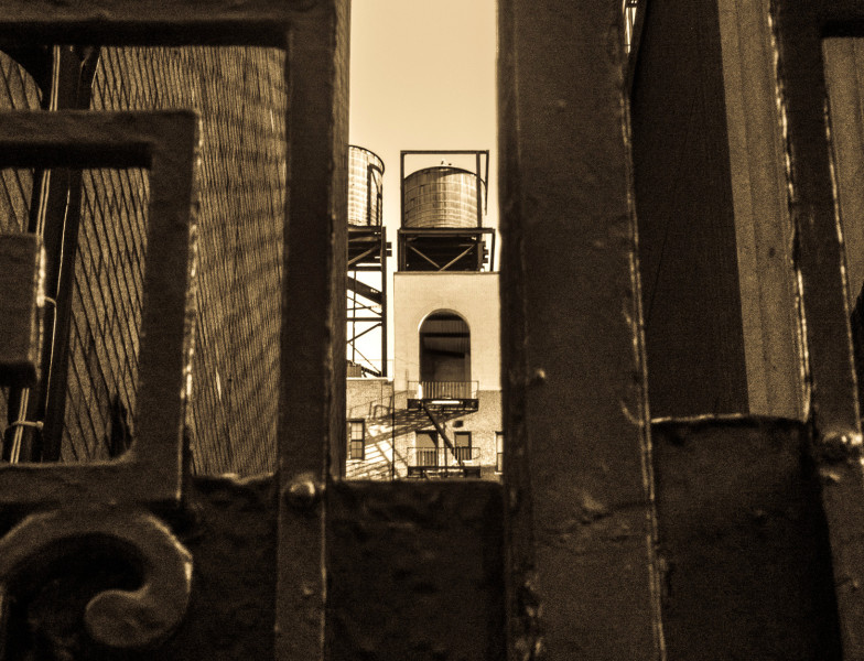 Ben Asen Personal Work: Black and white photo looking through gate at New York City Water Tower